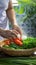 Photo Close up of womans hand placing organic vegetables into bamboo basket