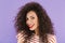 Photo closeup of adorable trendy woman with curly hair in summer