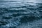 Photo closeup of beautiful clear dark blue sea ocean water surface with ripples low waves on seascape background.