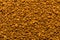 Photo of closeup texture of brown milled instant coffee, background