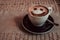 Photo of coffee cup of cappuccino on a saucer with print a smile on foam