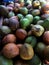 Photo of a collection of brown and green coconuts