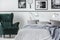 Photo collector bedroom with emerald armchair and king size bed with grey bedding