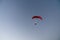 Photo of colorful hang glider flying in the sky