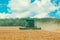 Photo of combine harvester that is harvesting crop