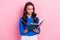 Photo of concentrated intelligent lady wear blue trendy clothes hold copybook make notes write plan  on pink