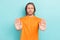 Photo of confident charming guy wear orange t-shirt rising palms showing no isolated teal color background