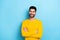 Photo of confident dreamy man wear yellow sweater arms folded looking empty space isolated blue color background