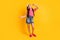 Photo of confident funny school girl wear pink t-shirt smiling dancing isolated yellow color background