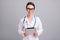 Photo of confident positive young lady doctor workwear glasses smiling typing modern gadget isolated grey color