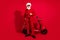 Photo of confident santa claus ready ride retro bike wear sunglass x-mas hat suit on red color background