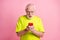 Photo of confused aged guy unexpected post staring wear lime clothing isolated on pink color background
