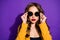 Photo of cool astonishing girl watching into camera through sunglass while being isolated with purple background