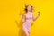 Photo of cool blond hairdo young lady hold spectacles look empty space wear pink dress isolated on bright yellow color