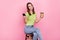 Photo of cool brunette young lady coffee break pause hold telephone wear green t-shirt isolated on pink color background