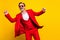 Photo of cool cheerful guy in red three-piece suit dancing enjoying free time holiday isolated on yellow color
