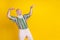 Photo of cool cheerful man wear colorful shirt having fun looking empty space isolated yellow color background