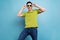 Photo of cool impressed young guy dressed green t-shirt arms dark eyewear dancing smiling isolated blue color background
