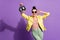 Photo of cool positive girl hold glitter discotheque ball touch specs isolated over violet color background