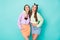 Photo of cool two cheerful lady friends cool youth look clothes hugging good mood wear cropped sweaters pullovers naked