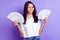 Photo of coquette lady hold two cash fan blink eye wear white shirt isolated violet color background