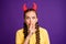 Photo of crazy childish lady holding finger on lips frightening evil facial expression wear halloween red horns casual