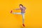 Photo of crazy fighter girl jump kick leg air wear striped shirt jeans shoes isolated yellow color background