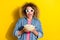 Photo of crazy funky lady hold bowl popcorn watch movie wear 3d glasses jeans shirt isolated yellow color background
