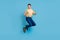 Photo of crazy funny dream guy jump have fun wear suspenders shirt bow tie isolated blue color background
