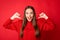 Photo of crazy girl point thumb finger at herself wear jumper isolated over bright shine red color background