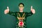 Photo of crazy party guy raise thumb up wear glasses deer ornament pullover isolated green color background