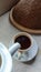 Photo of a cup of coffee and a mug with a traditional theme, using a ceramic base material