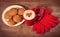 Photo of cup of coffee, plate full of cookies and warm gloves
