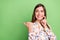 Photo of curious brunette hairdo young lady point look empty space wear white blouse isolated on green color background