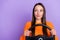 Photo of curious dreamy lady hold steering wheel look empty space wear orange sweater isolated purple color background