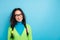 Photo of curious funky happy young woman look empty space dream creative plan isolated on blue color background