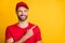 Photo of curious guy indicate finger look empty space wear red t-shirt hat isolated yellow color background