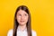 Photo of curious thoughtful schoolgirl look empty space think wear white shirt isolated yellow color background