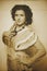 Photo of curly brunette in retro style with sepia effect