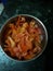 This is the photo of cut pieces of tomato in bowl .