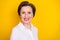 Photo of cute adorable mature lady wear white clothes empty space smiling isolated yellow color background