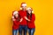 Photo of cute affectionate adorable family smiling toothily hugging each other wearing jeans denim santa cap headwear