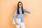 Photo of cute brunette millennial lady hold laptop thumb up wear spectacles turtleneck pants  on beige