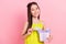 Photo of cute charming preteen school girl wear yellow clothes smiling holding birthday gift isolated pink color