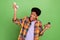 Photo of cute excited dark skin man wear plaid shirt smiling holding herb mills isolated green color background