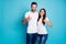 Photo of cute marriage pair raising thumbs up wear casual outfit isolated blue background