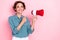 Photo of cute nice adorable optimistic girl bob hairstyle dressed blue blouse showing holding megaphone isolated on pink