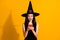 Photo of cute pretty young magician lady hold telephone excited look open mouth friend invite cosplay event wear black