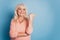 Photo of cute retired lady indicate thumb side empty space