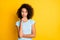 Photo of cute thoughtful dark skin girl dressed blue t-shirt looking empty space arm chin isolated yellow color